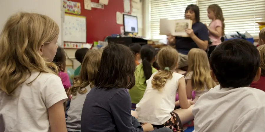 a group of children sitting in a classroom
