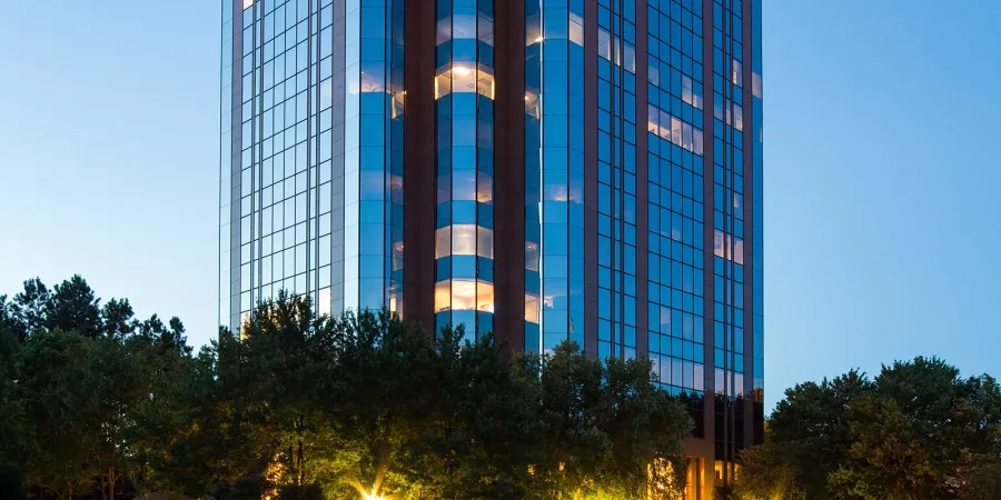 a tall building with trees in front of it