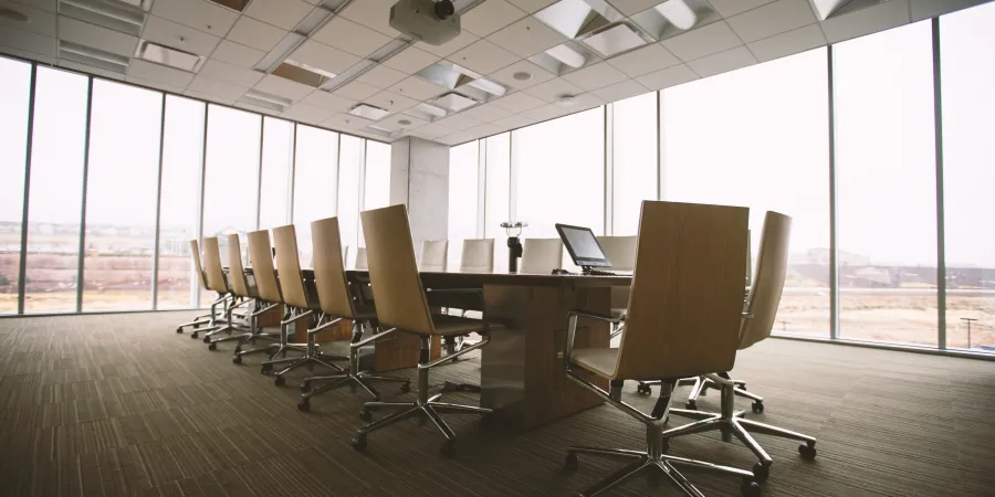a room with a desk and chairs