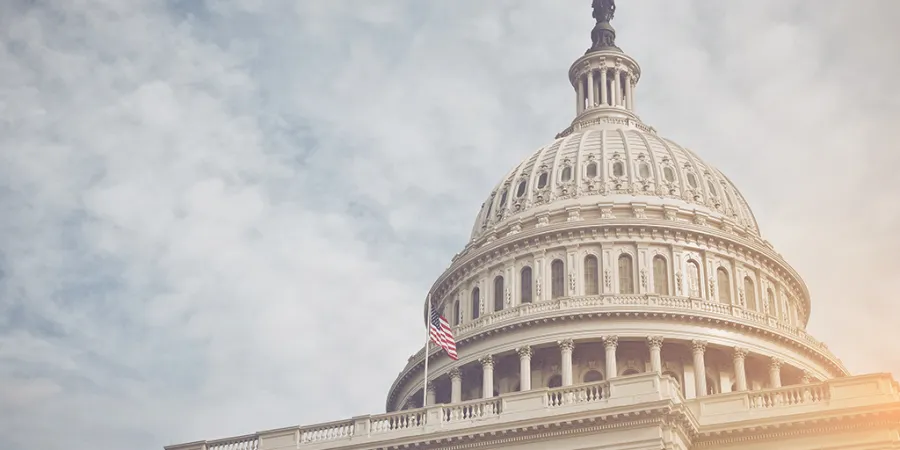 a large white building with United States Capitol in the background