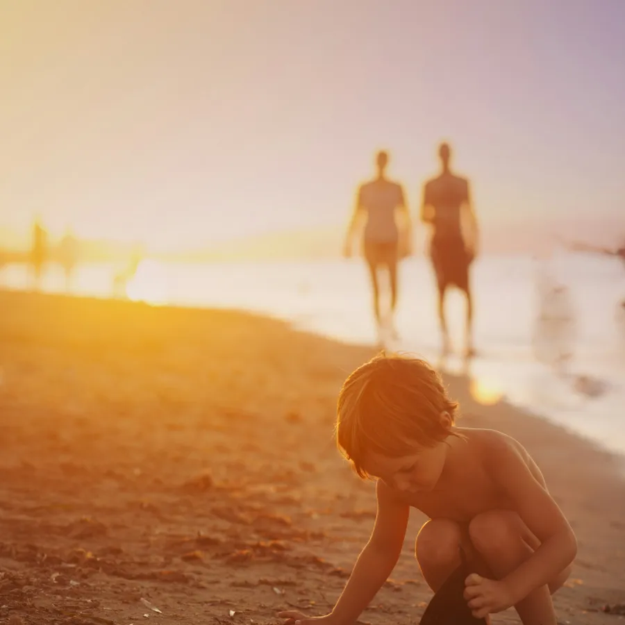 a baby playing on the beach