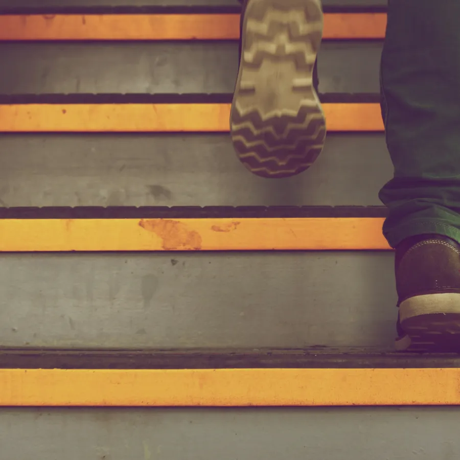 a person's legs and feet on a staircase