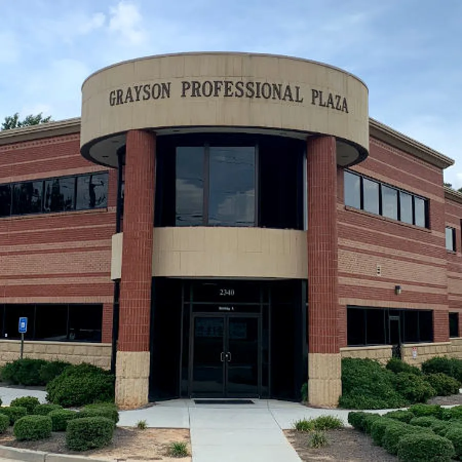 Grayson Professional Plaza building with a circular entrance and landscaping in front.