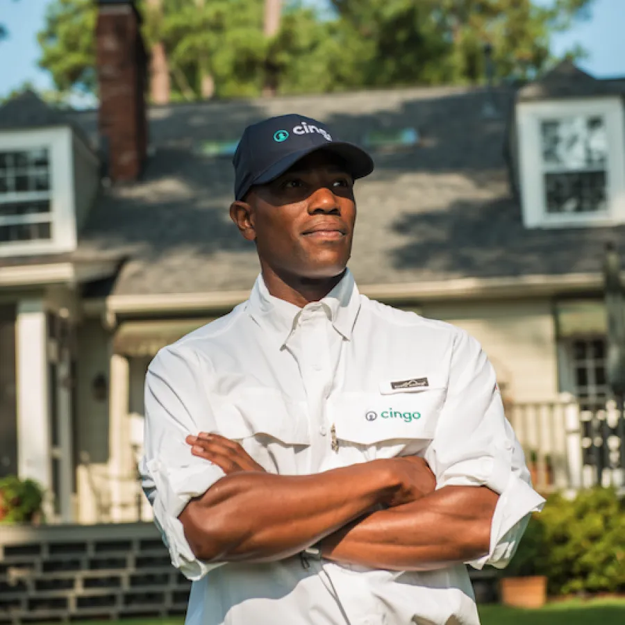 Handsome Cingo employee staring off into distance in front of a pest free home