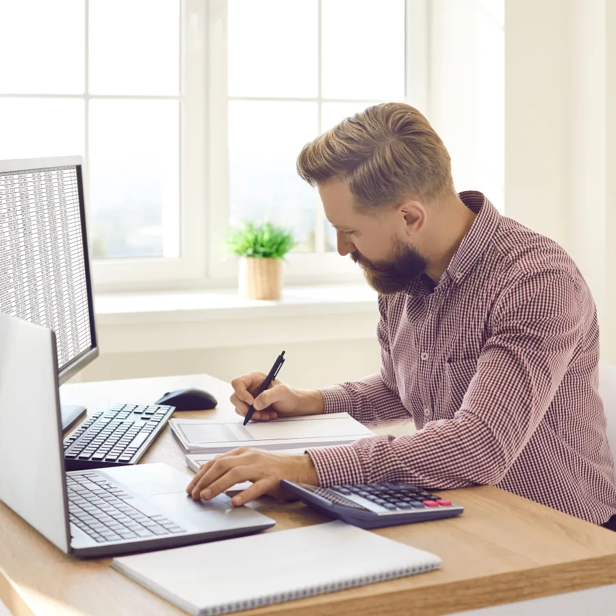 a person writing on a laptop