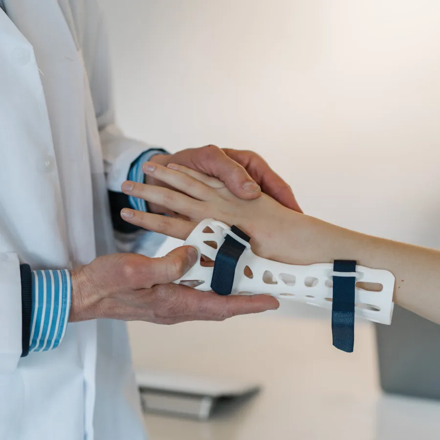 a close-up of hands holding a cast