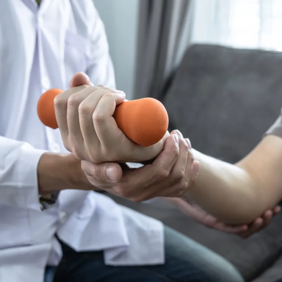 a person holding an orange weight