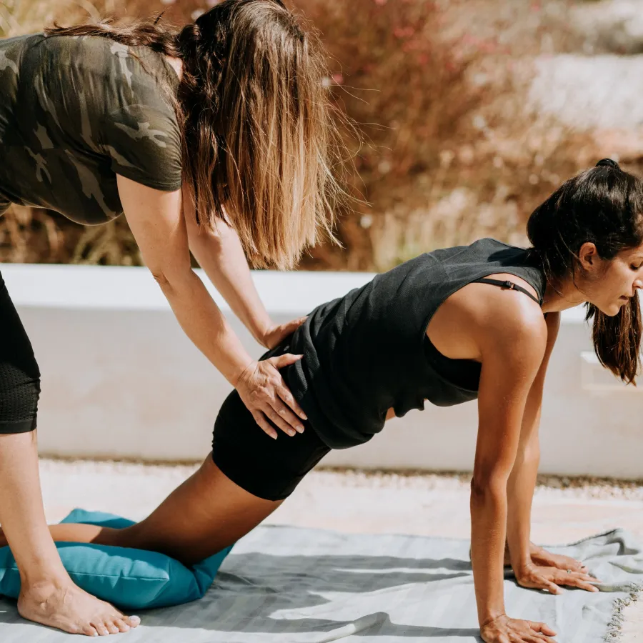 a person doing yoga on the beach