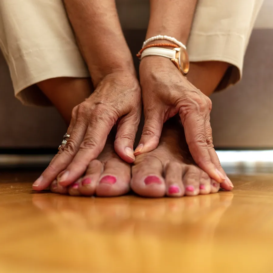 a pair of hands on their feet