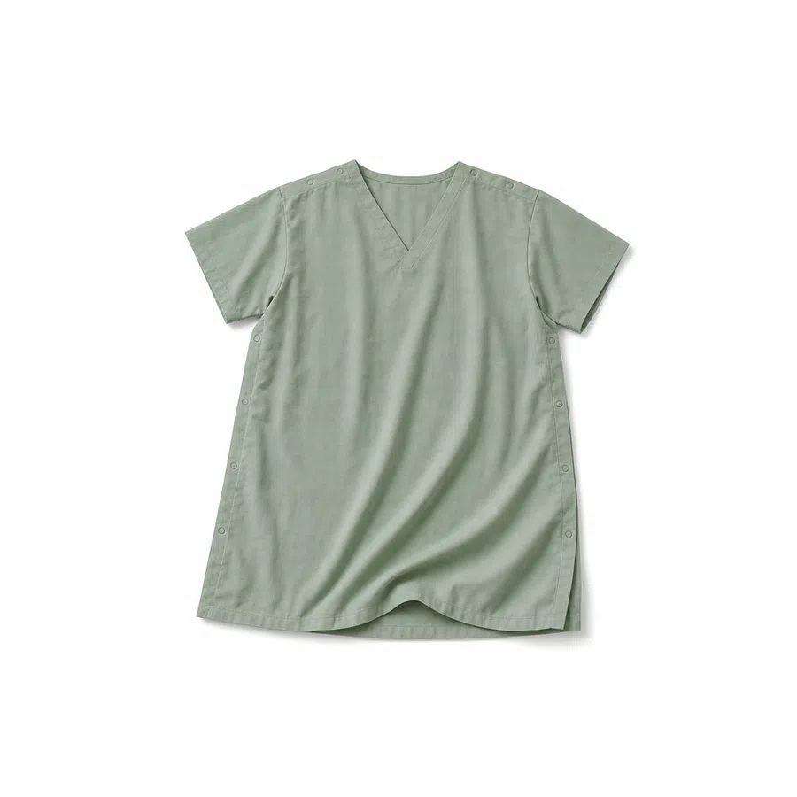 Light green short-sleeve V-neck scrub top with snap buttons on shoulders and sides laid flat on white background