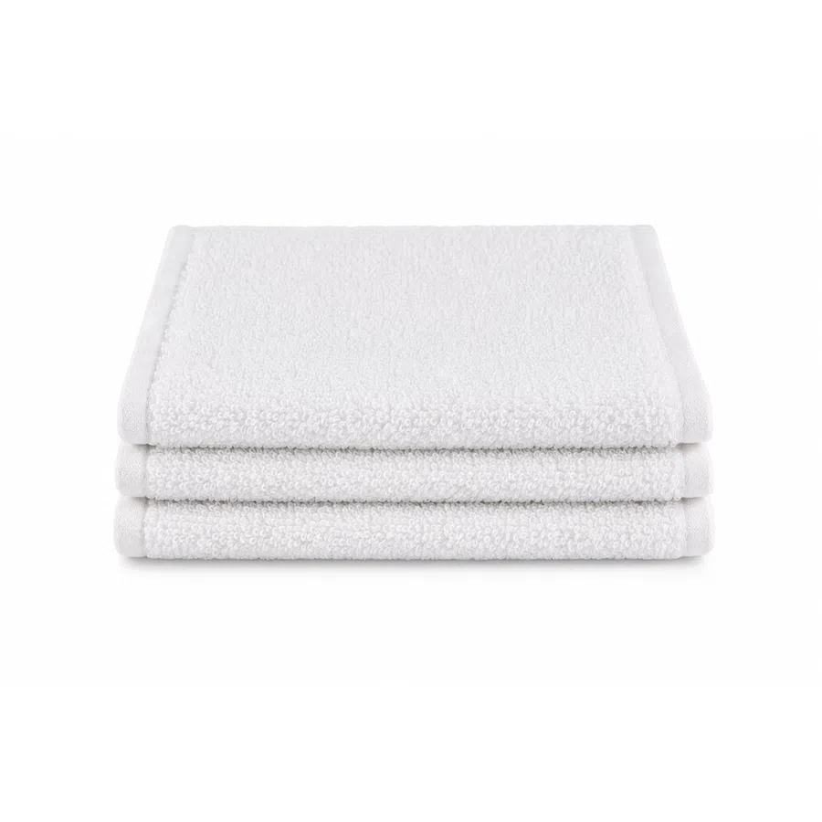 Stack of three neatly folded white cotton washcloths on a white background.