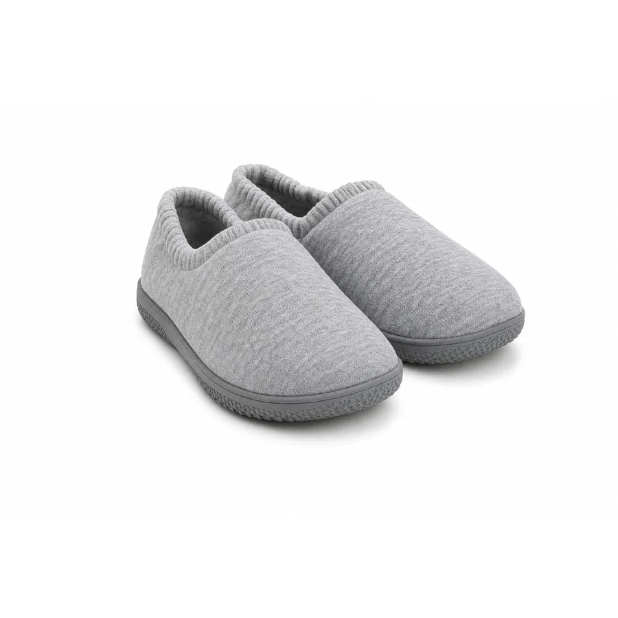 Pair of gray slip-on indoor slippers with textured knit fabric and rubber soles against white background.