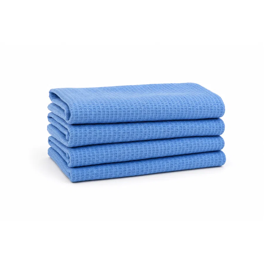 Stack of four neatly folded blue waffle-textured towels on white background