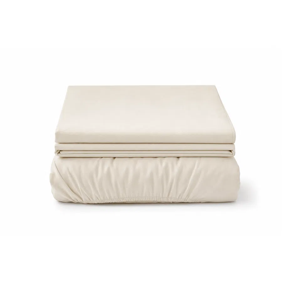 Stack of neatly folded beige bed sheets including a fitted sheet and flat sheet on a white background