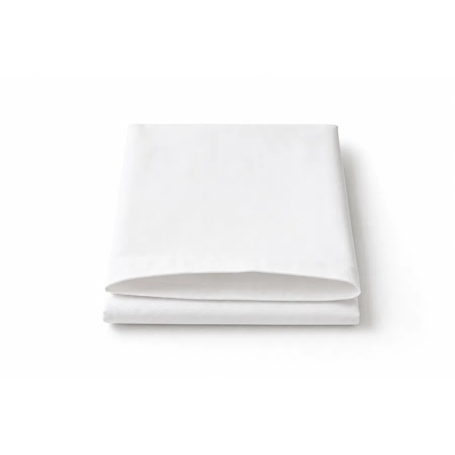 Neatly folded white bedsheet on a white background highlighting softness and smooth texture.