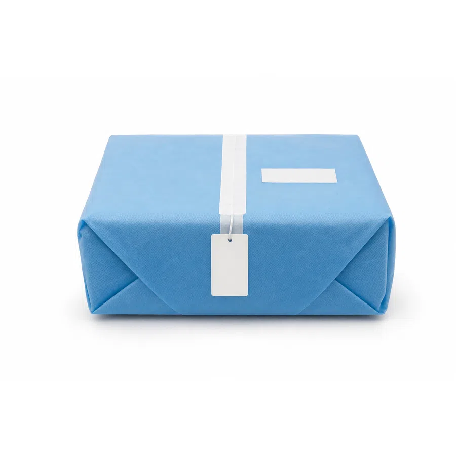 Blue parcel wrapped with white tape and blank white labels on white background.