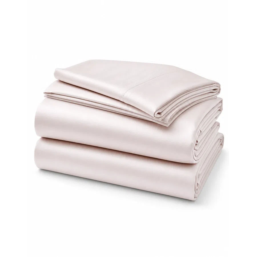 Smooth, light pink silk bed sheets neatly folded on a white background.