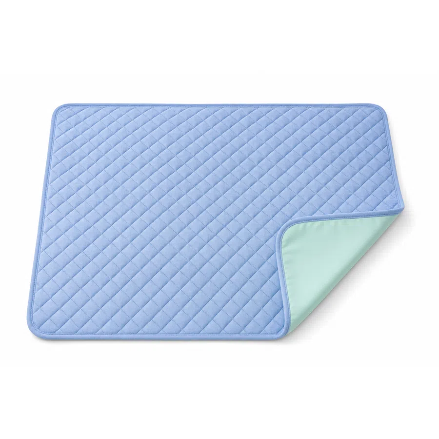 Blue quilted rectangular pet training pad with one corner flipped to reveal waterproof layer underneath.