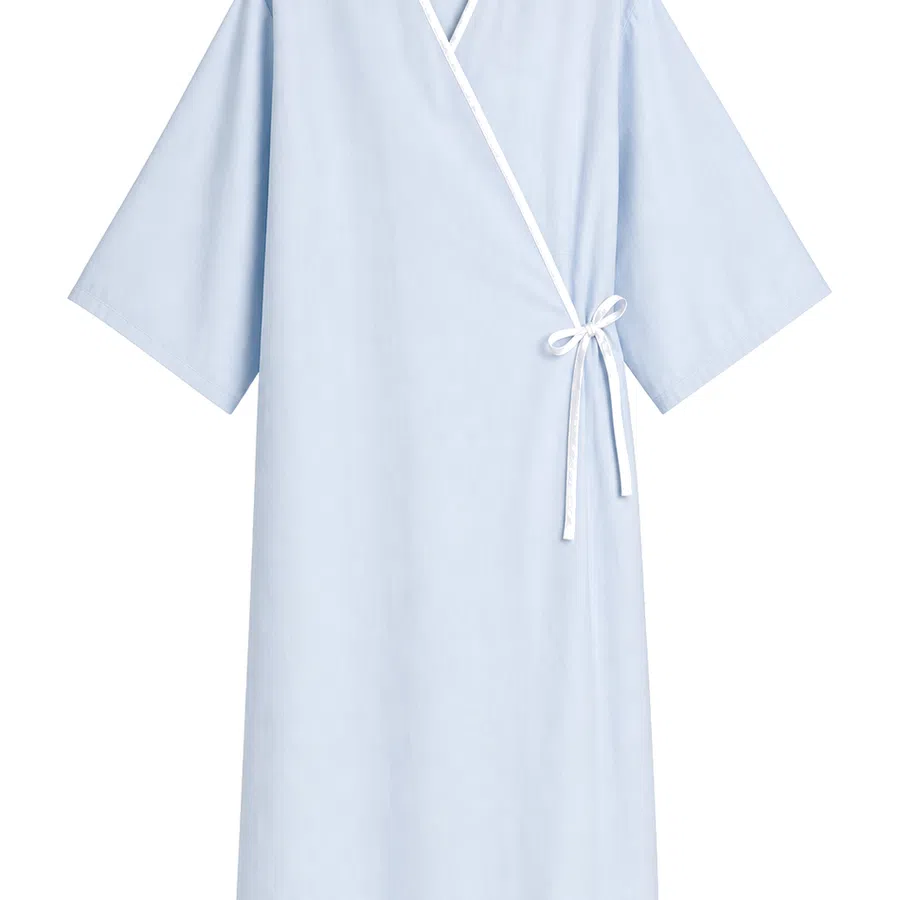 Light blue medical gown with white trim and side tie, designed for hospital or clinical use.