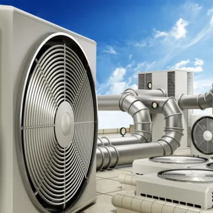 Modern industrial HVAC units with large fans and connected ductwork on a rooftop under blue sky.
