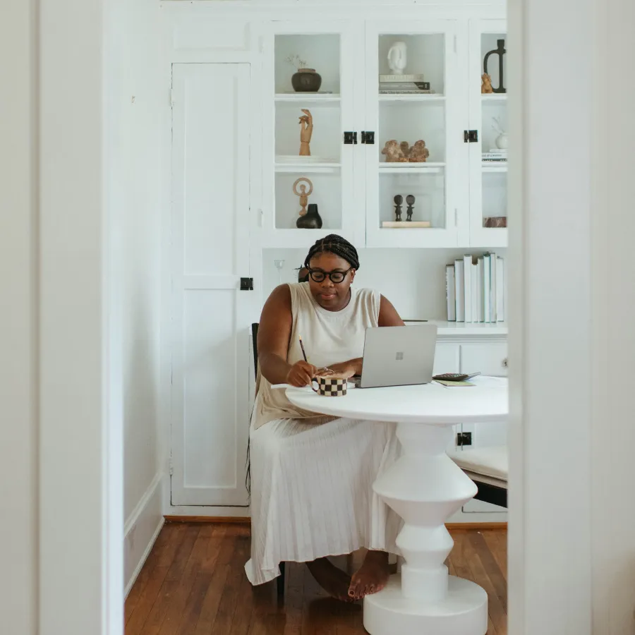 a person sitting at a desk with a laptop