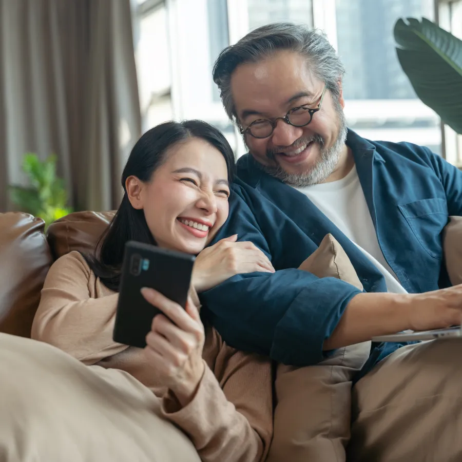 a man and a woman looking at a laptop