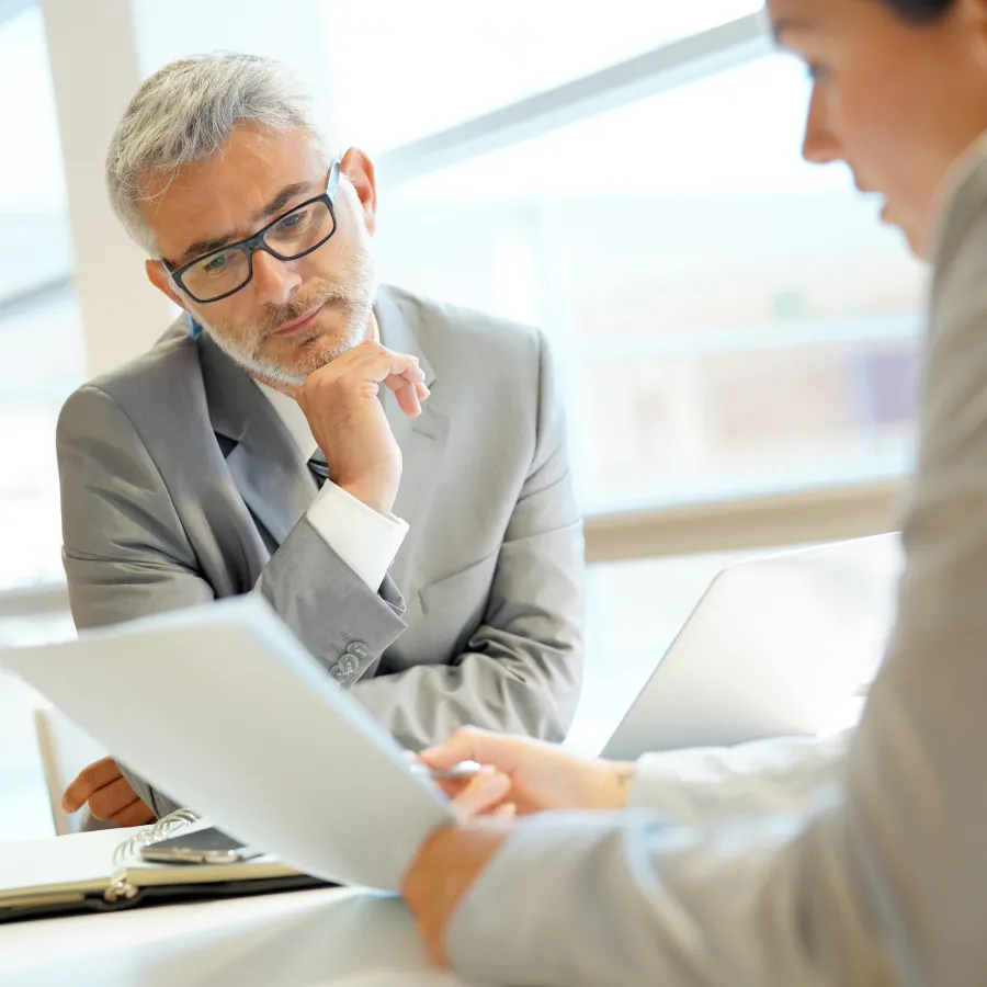 a man and a woman looking at a piece of paper