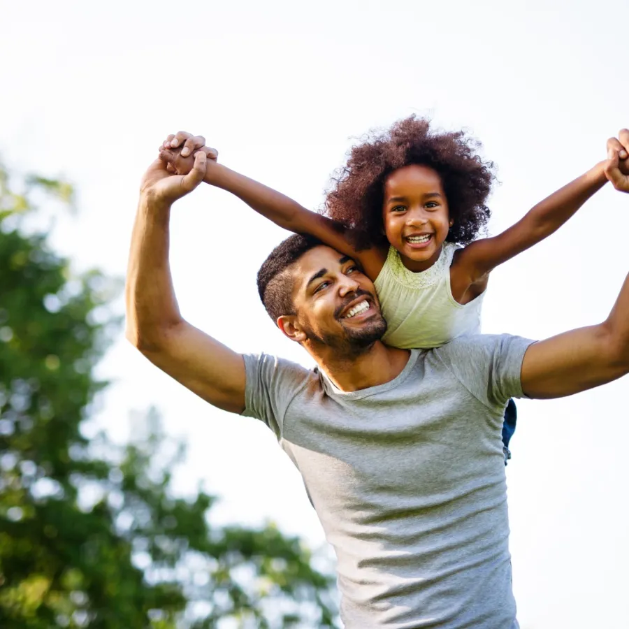a father carrying his daughter