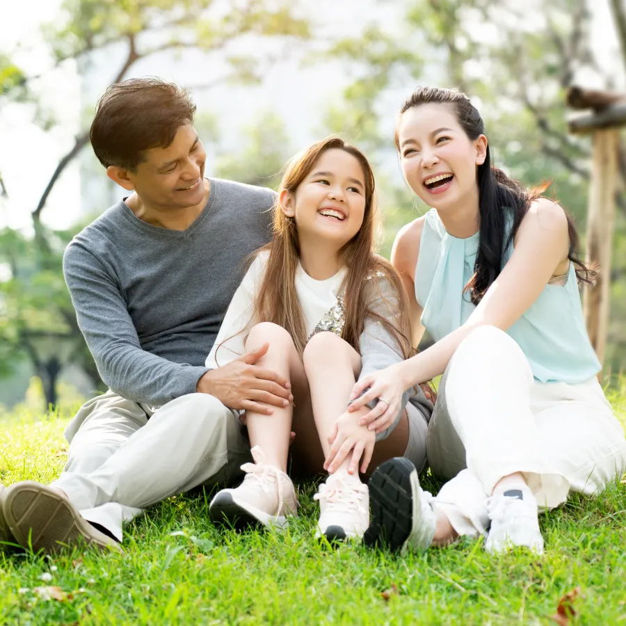 a family sitting on the grass