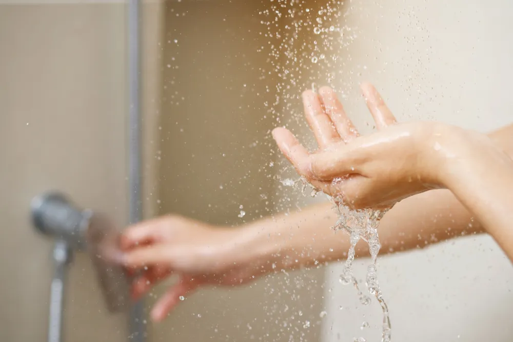 a person washing hands in a sink