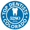 Blue circular badge with white tooth icon, text Top Dentists Colorado, number 5280, and year 2026.