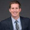 a man in a suit smiling
