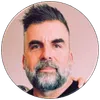 Portrait of a middle-aged man with salt-and-pepper beard and short hairstyle against a neutral background