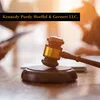 Wooden judge's gavel on desk with blurred background and law firm name Kennedy Purdy Hoeffel & Gernert LLC.