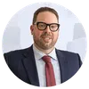 a man wearing glasses and a suit