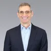 a man wearing glasses and a suit