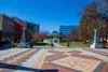 Decatur City plaza with patterned pavement, gazebo, autumn trees, and modern buildings under a clear blue sky