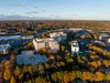 Aerial view of a Johns Creek in Georgia by autumn trees under a clear sky.