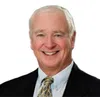 a man in a suit smiling