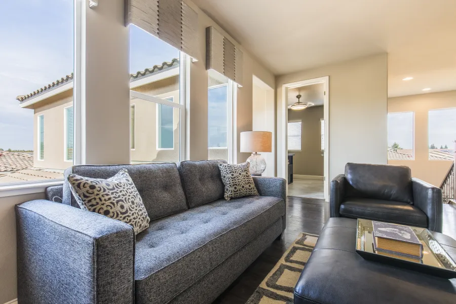 a living room filled with furniture and a large window