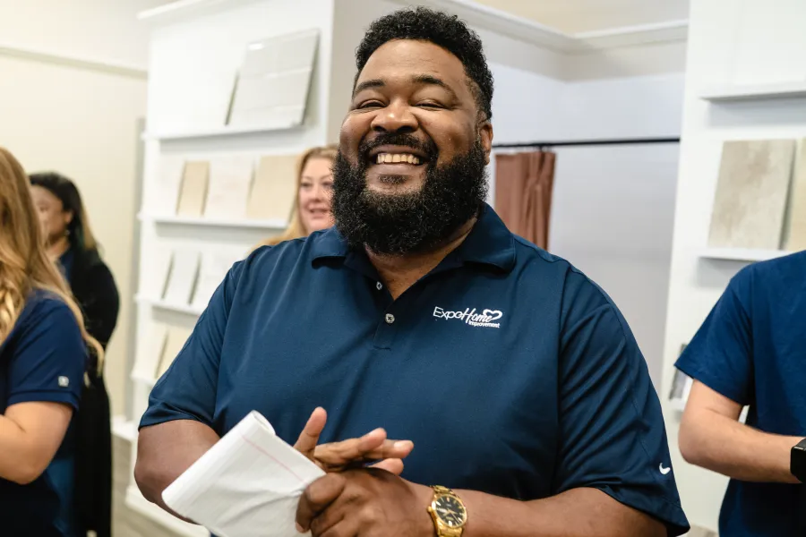 George Duke holding a paper and smiling