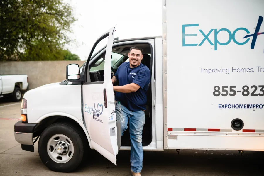 a man standing in the back of a white truck