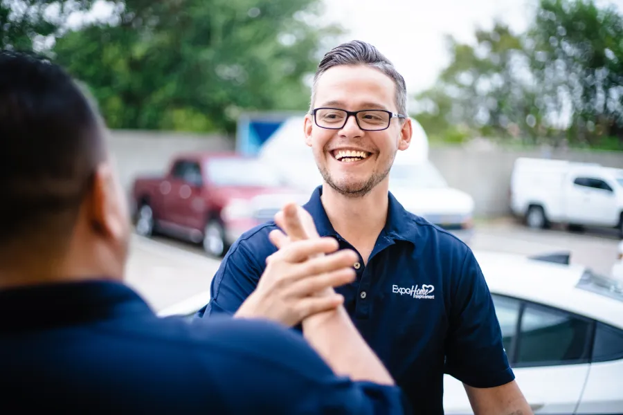 a man in glasses smiling