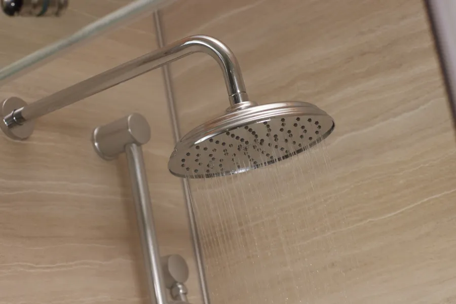 a metal faucet on a wooden surface