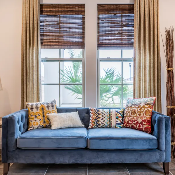 a couch with pillows and pillows in front of a window