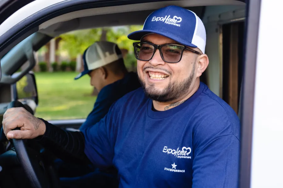 a man smiling with a couple of boys in the back of a car