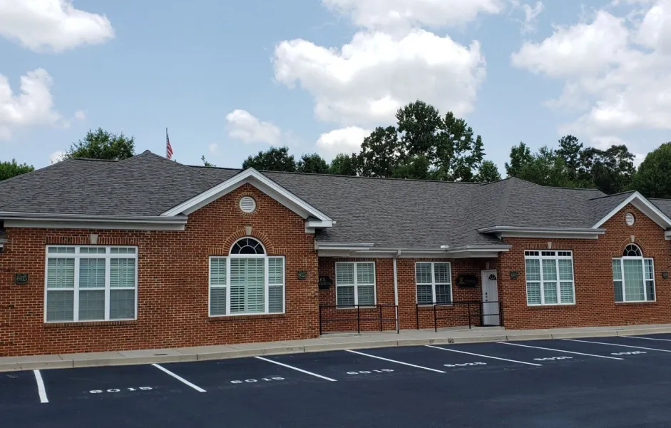 a brick building with a parking lot