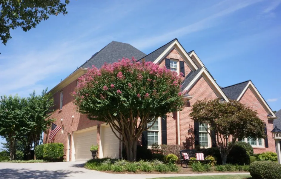 a large house with a tree in front of it