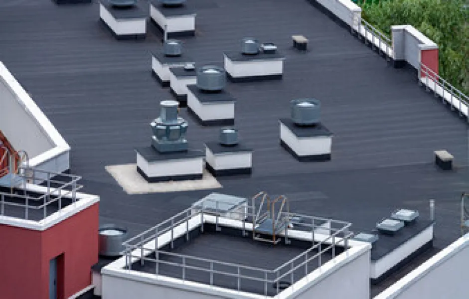 a rooftop with a few tables and chairs