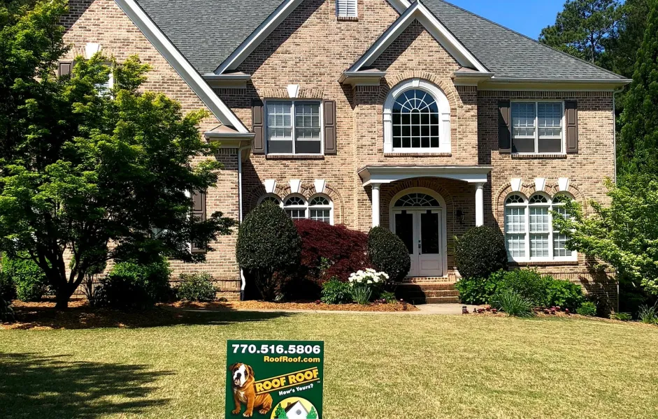 a brick house with a sign in front of it